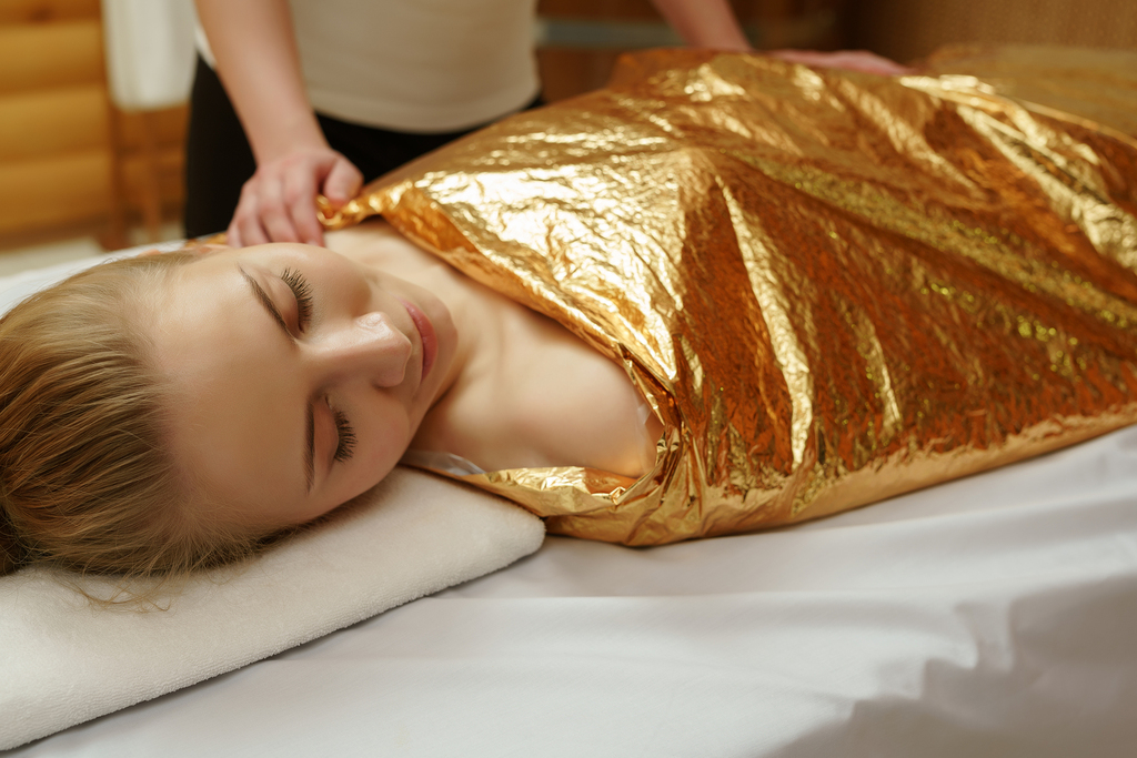 woman receiving a body wrap treatment