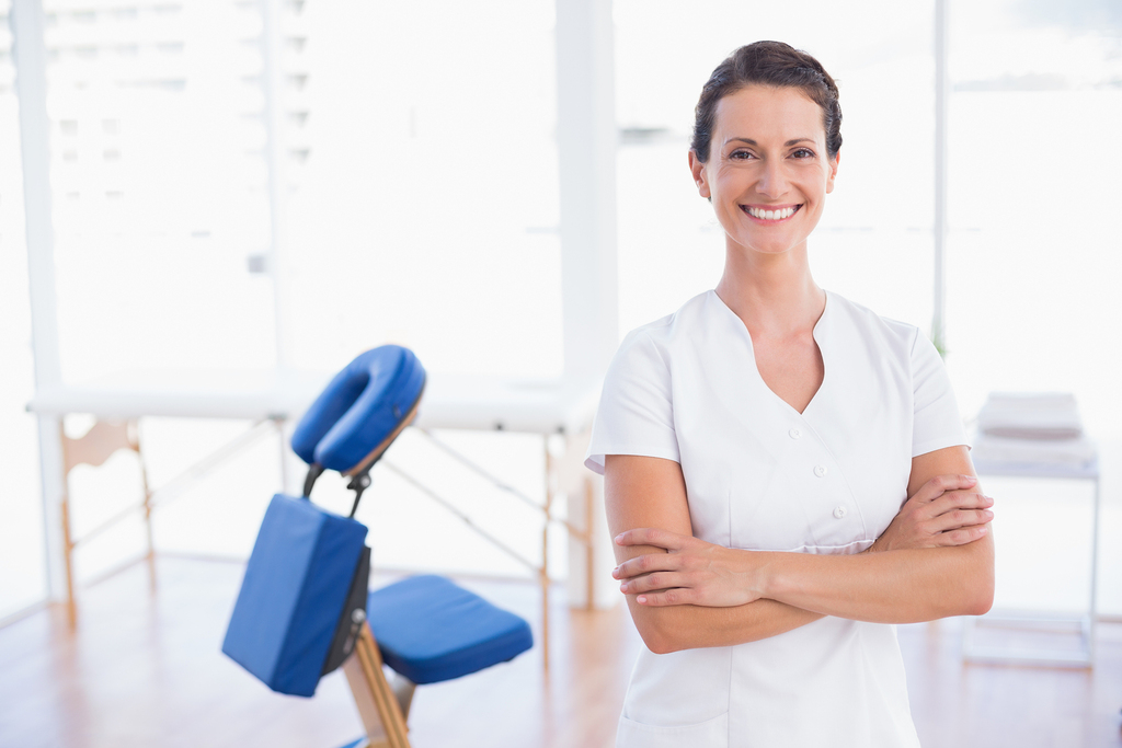 Smiling therapist, massage chair