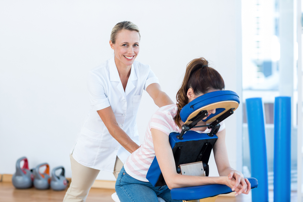 smiling massage therapist, chair massage